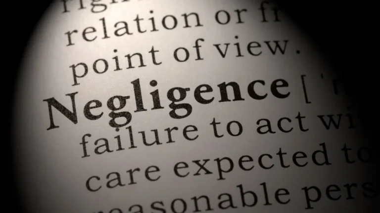 Close-up of a dictionary page highlighting the word "Negligence" in bold text.