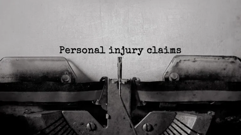 Close-up of an old typewriter typing "Personal injury claims" on white paper.