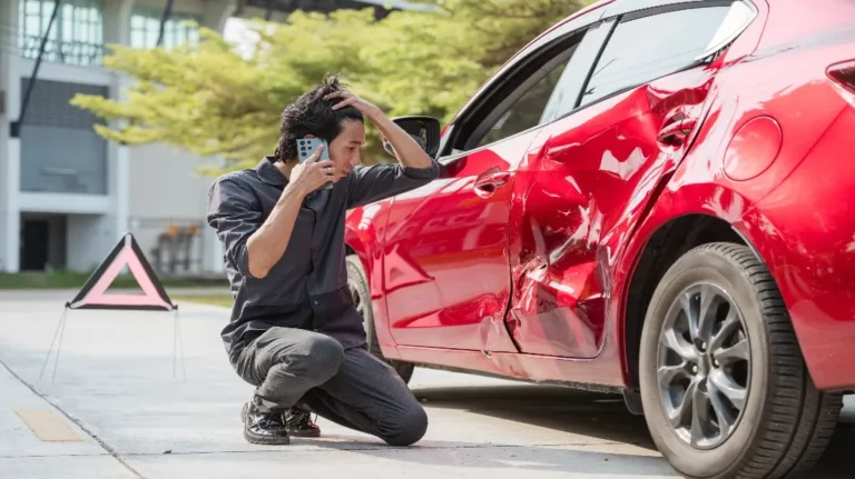 man looking at result of car accident