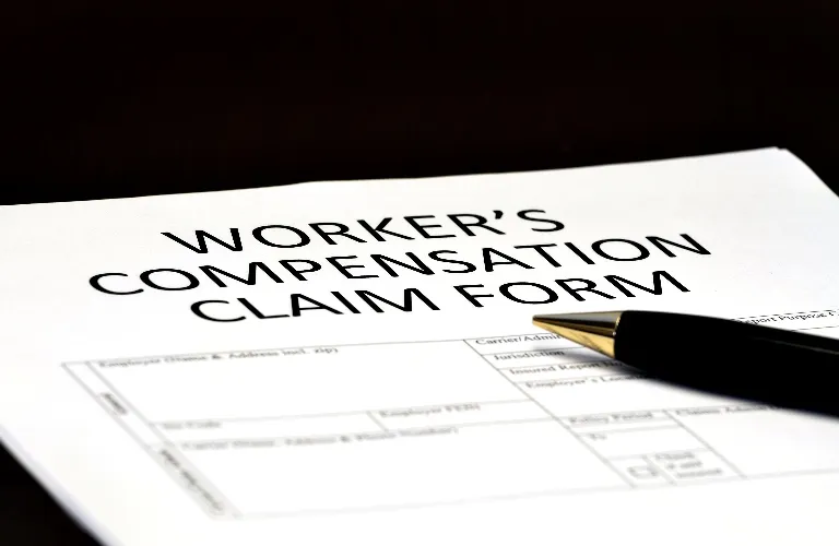 workers compensation claim form and pen